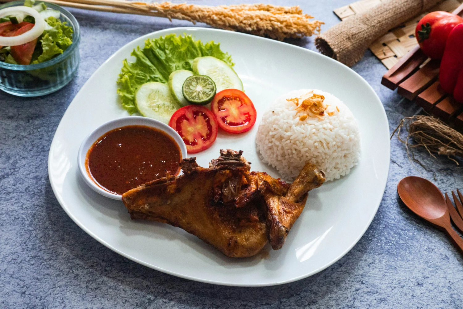 Dinner plate with salad, grilled chicken, and rice.